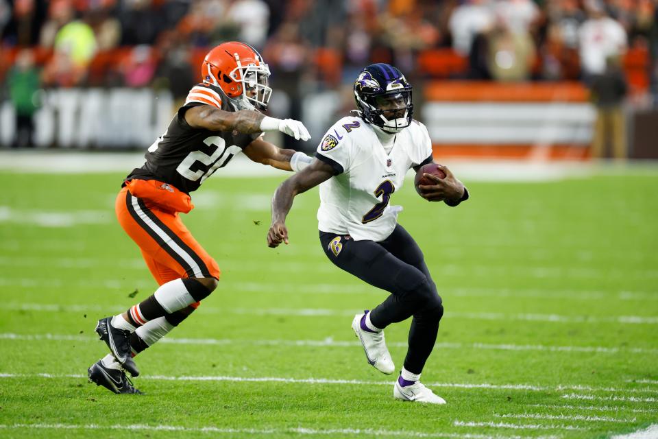 Baltimore Ravens quarterback Tyler Huntley carries the ball as Cleveland Browns cornerback Greg Newsome II defends during the first half of an NFL football game, Saturday, Dec. 17, 2022, in Cleveland. (AP Photo/Ron Schwane)