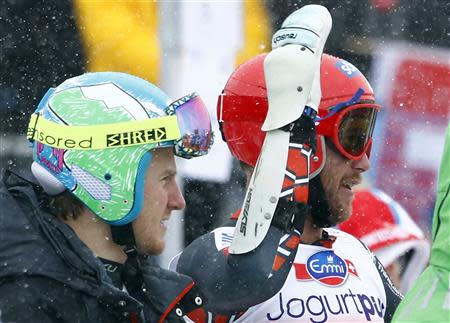 Bode Miller of the U.S. (R) gestures next to compatriot Ted Ligety after the first run of the men's World Cup giant slalom race in St. Moritz February 2, 2014. REUTERS/Michaela Rehle