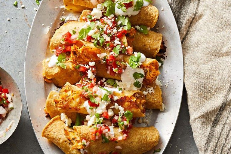 <p>Who doesn't love a good taquito? These ones are made with chicken, enchilada sauce, corn tortillas, and two types of cheese. Top them off with pico de gallo and crumbled cotija cheese for that extra special touch. </p><p>Get the <a href="https://www.goodhousekeeping.com/food-recipes/a38540427/chicken-taquitos-recipe/" rel="nofollow noopener" target="_blank" data-ylk="slk:Chicken Taquitos recipe;elm:context_link;itc:0;sec:content-canvas" class="link ">C<strong>hicken Taquitos recipe</strong></a>. </p>