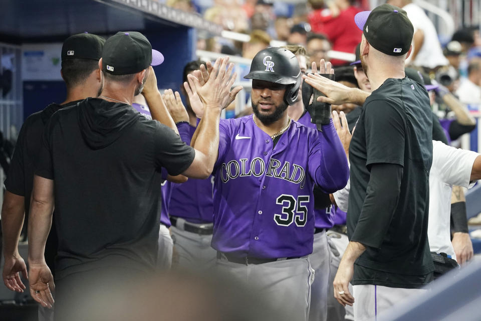 Colorado Rockies' Elias Diaz (35) celebrates after scoring a run on a three-run home run by Nolan Jones in the seventh inning of a baseball game against the Miami Marlins, Saturday, July 22, 2023, in Miami. (AP Photo/Marta Lavandier)