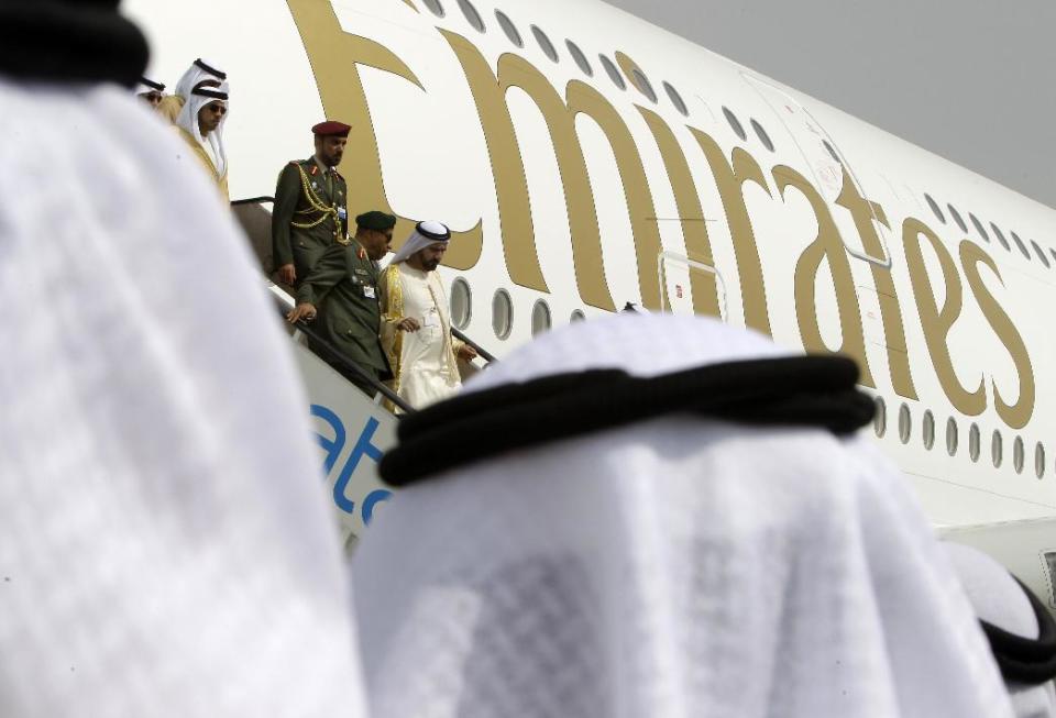 UAE Vice President, Prime Minister and Ruler of Dubai, Sheikh Mohammed bin Rashid Al Maktoum, center, disembarks from an Emirates Airbus A380 during the opening day of the Dubai Airshow in Dubai, United Arab Emirates, Sunday Nov. 17, 2013. Boeing Co.'s planned 777X long-haul airliner grabbed the bulk of orders Sunday at the first day of the Dubai Airshow, with at least 225 planes on the books in an eye-popping display of the spending power and aggressive expansion efforts of Gulf carriers. (AP Photo/Kamran Jebreili)