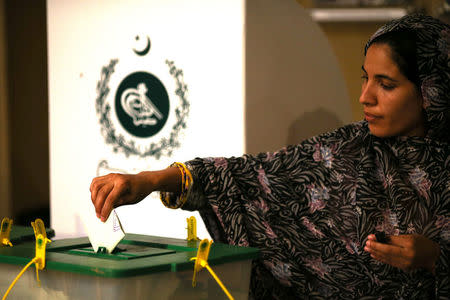 A voter casts her vote at a polling station during the general election in Islamabad, Pakistan, July 25, 2018. REUTERS/Athit Perawongmetha/Files