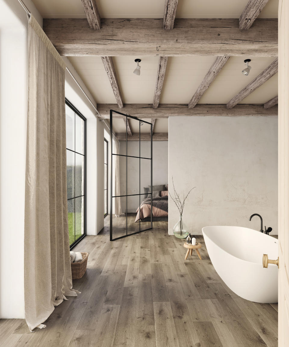 <p> Combining wooden beams, with organic linen to provide privacy, chalky plastered walls, and black-framed doors and windows, this rustic bathroom has been given a contemporary makeover. </p> <p> This water-resistant flooring by Carpetright is suitable for use with underfloor heating and a perfect match for modern living. </p>