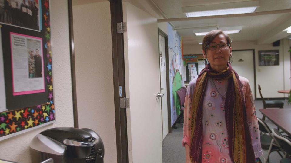 Diane Ujiiye walking through AADAP's office in South Los Angeles. (Photo: HuffPost / Shirley Chan)