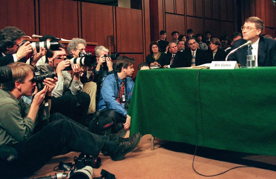 Photographers focus on Microsoft Chairman Bill Gates as he testifies during hearings before the US Senate Judiciary Committee on Capitol Hill in Washington, DC. March 3, 1998. (JESSICA PERSSON/AFP/Getty Images)