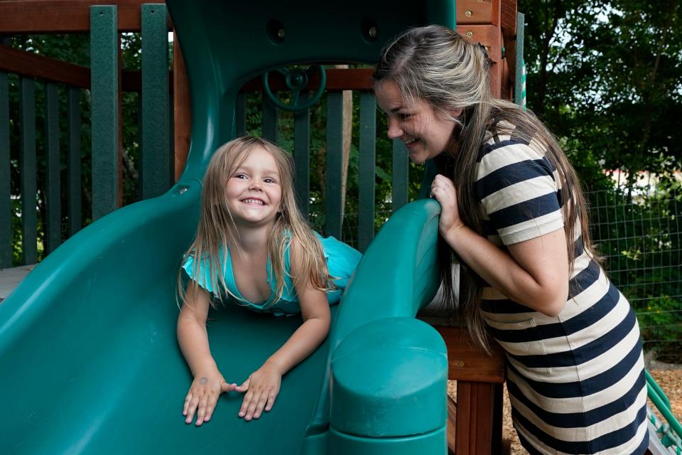 In this July 26, 2021 photo, Brianne Walker plays with her 3-year-old daughter, Jeannette, at A Place To Grow daycare in Brentwood, N.H. Walker and her family have qualified for the expanded child tax credit, part of President Joe Biden's $1.9 trillion coronavirus relief package.