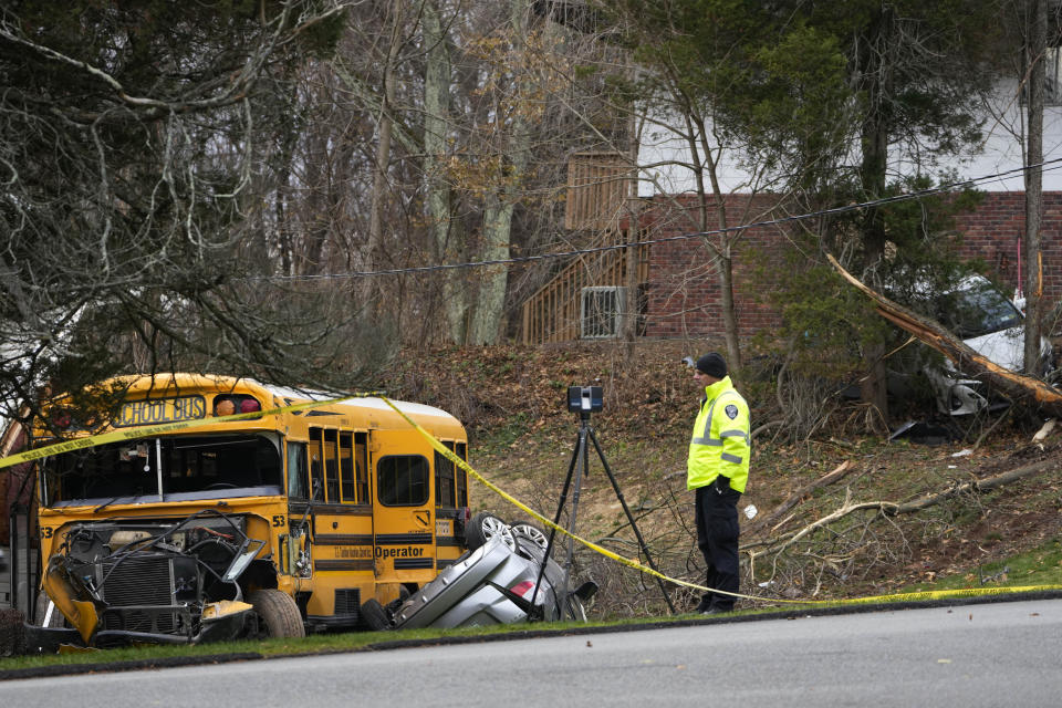 A school bus and other cars involved in an accident are seen in New Hempstead, N.Y., Thursday, Dec. 1, 2022. Multiple injuries were reported Thursday when a school bus crashed into a house and another vehicle in a suburb north of New York City. (AP Photo/Seth Wenig)