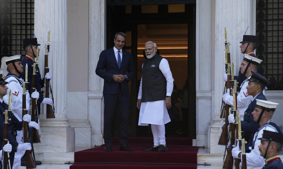 Greece's Prime Minister Kyriakos Mitsotakis, left, welcomes his Indian counterpart Narendra Modi at Maximos Mansion in Athens, Greece, Friday, Aug. 25, 2023. Modi's visit to Athens is especially significant for Greek foreign policy as it is the first official visit by an Indian prime minister to Greece in 40 years. (AP Photo/Thanassis Stavrakis)