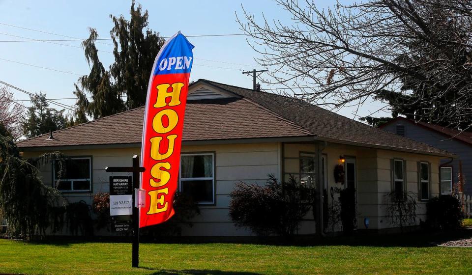 A large open house flag unfurls outside a Cedar Avenue home in Richland listed with Shannon Jones of Berkshire Hathaway HomeServices. Spring heralds the start of the busiest season for home selling.