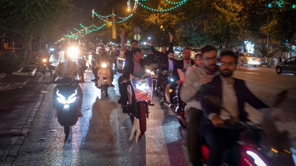 Supporters of Iranian presidential candidate Mohammad Baqer Qalibaf ride motorcycles on Revolution Avenue in Tehran