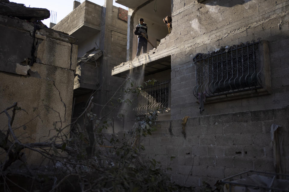 Palestinians check destruction after an Israeli strike in Rafah, Gaza Strip, Wednesday, Feb. 21, 2024. (AP Photo/Fatima Shbair)