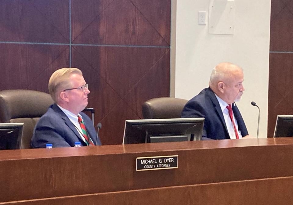 County Attorney Mike Dyer and County Manager George Recktenwald listen to County Council during their annual performance review on Tuesday.