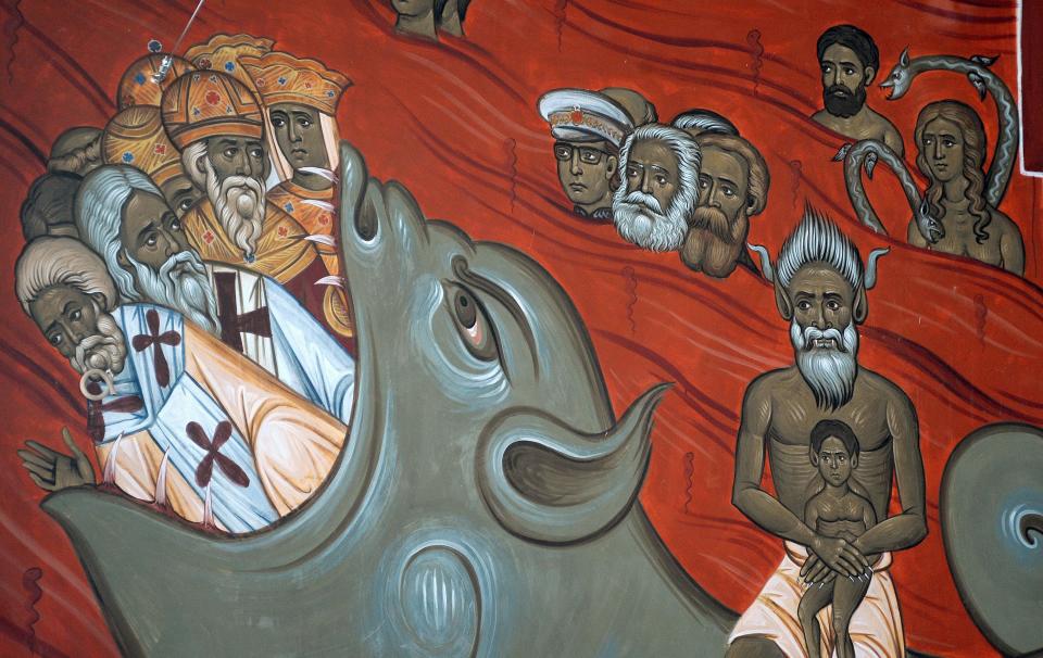 This photo taken Tuesday, Feb. 4, 2014 shows the brightly-colored newly painted fresco in the Serbian Orthodox Church of Christ's Resurrection in Montenegro's capital Podgorica. The fresco allegedly shows late Yugoslav autocratic leader Josip Broz Tito drowning in red fiery waves of hell with Karl Marx and Friedrich Engels, authors of the 1848 Communist Manifesto. They are in the company of Adam and Eve, together with some of Montenegro's current politicians and people wearing Muslim turbans. What appear to be rival church priests are being swallowed through a huge jaw of an angry gray beast with pointed devil ears. The fresco has triggered much attention and public controversy in this tiny former communist country. (AP Photo/Risto Bozovic)
