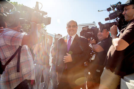 Mexican singer Luis Miguel's lawyer, Kris Demirjian, (C), ignores questions from various news outlets outside the Edward R. Roybal Federal Building in Los Angeles, California, U.S. May 2, 2017. REUTERS/Kyle Grillot