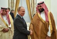 FILE - In this Thursday, June 14, 2018 file photo, President Vladimir Putin, shakes hands with Saudi Arabian Crown Prince Mohammed bin Salman, right, during their meeting in Moscow, Russia. (Yuri Kadobnov/Pool via AP)