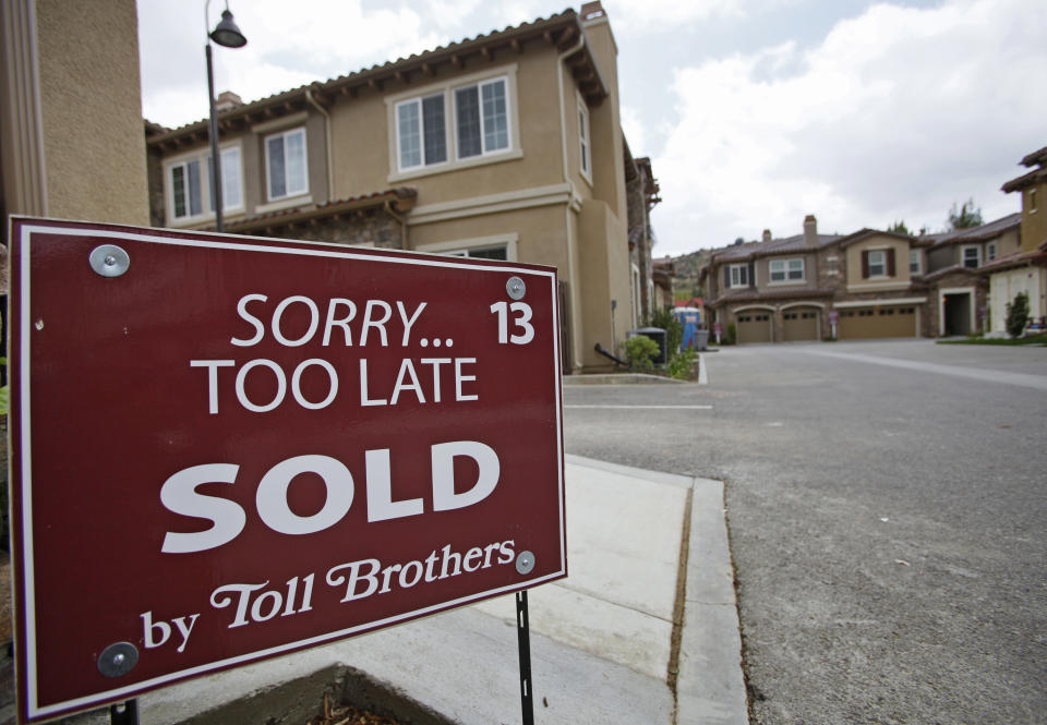 In this May 23, 2011 photo, a sold sign is posted at a new town home luxury property at 