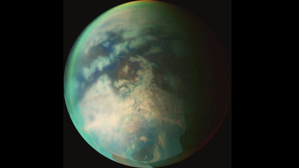 image of the huge saturn moon titan against the blackness of space