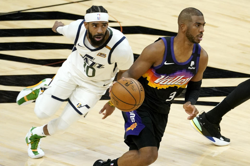 Phoenix Suns guard Chris Paul (3) drives as Utah Jazz guard Mike Conley (10) pursues during the first half of an NBA basketball game, Wednesday, April 7, 2021, in Phoenix. (AP Photo/Matt York)