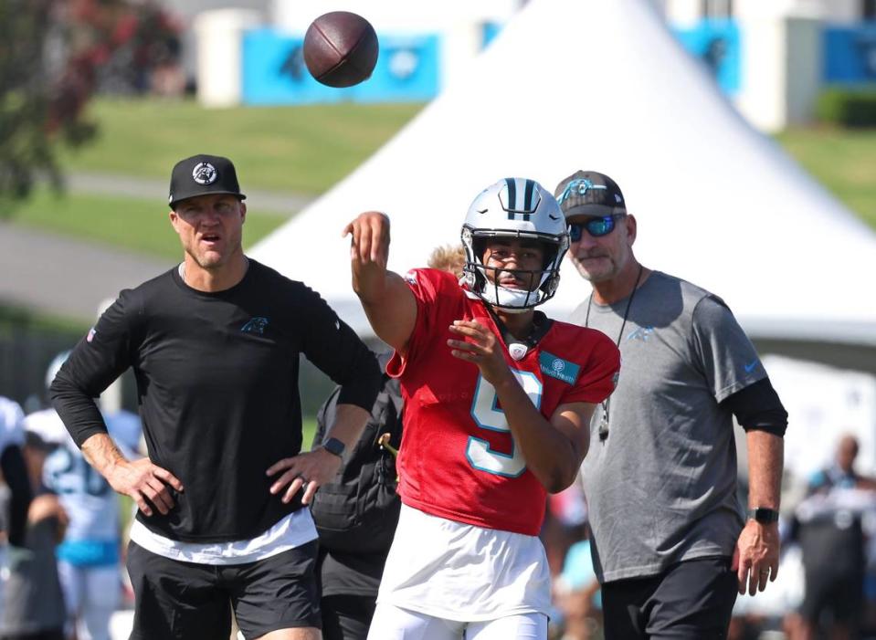 Carolina Panthers quarterbacks coach Josh McCown, left and head coach Frank Reich, right, watch as quarterback Bryce Young passes to a receiver during the team’s joint practice with the New York Jets on Wednesday, August 9, 2023 at Wofford College in Spartanburg, SC.