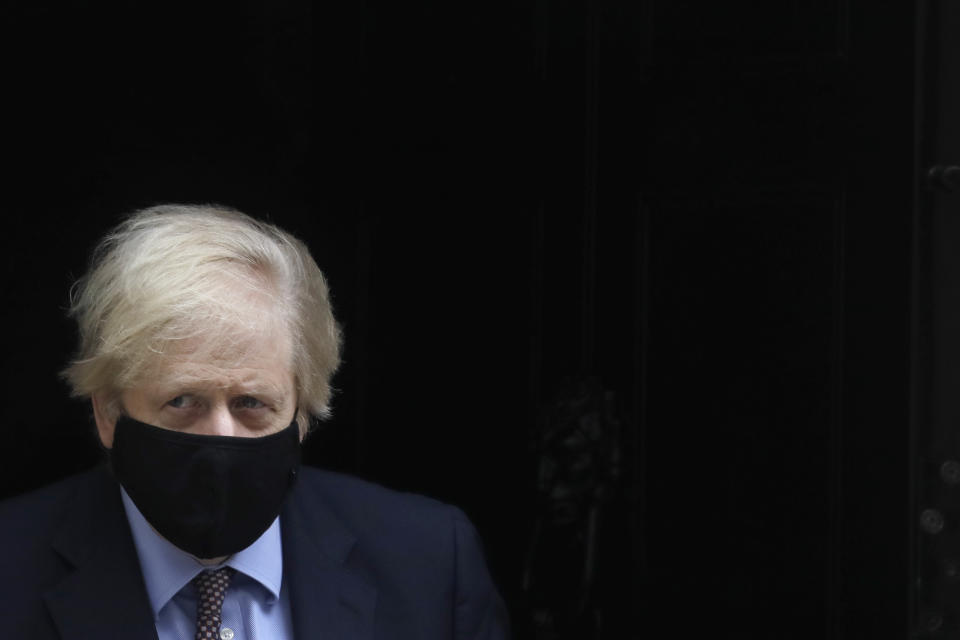 Britain's Prime Minister Boris Johnson leaves Downing Street to attend parliament in London, Wednesday, March 3, 2021. Britain's Chancellor Rishi Sunak is expected to announce billions of pounds in tax cuts and spending increases to help workers and businesses hit by the coronavirus pandemic when he delivers his budget to Parliament on Wednesday. (AP Photo/Kirsty Wigglesworth)