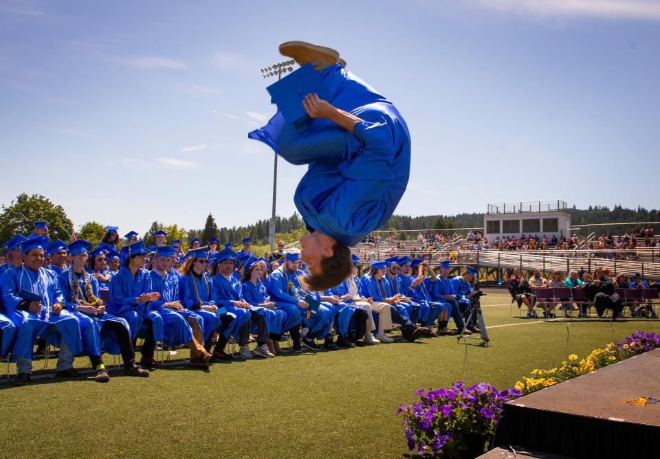 Karson Wilmarth does a flip off the stage after receiving his diploma during the Cottage Grove High School graduation ceremony in Cottage Grove June 10.