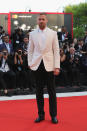 <p>Ryan paired black trousers with a white jacket and shirt for the premiere of his new film. <em>[Photo: Getty]</em> </p>