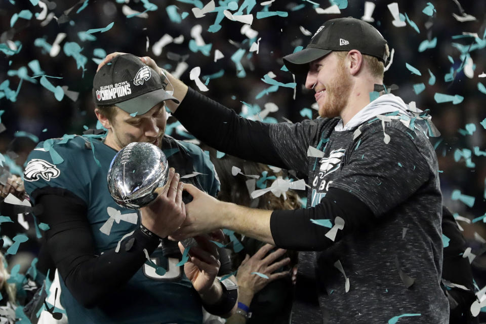 <p>Philadelphia Eagles quarterback Carson Wentz, right, hands the Vincent Lombardi trophy to Nick Foles after winning the NFL Super Bowl 52 football game against the New England Patriots, Sunday, Feb. 4, 2018, in Minneapolis. The Eagles won 41-33. (AP Photo/Frank Franklin II) </p>