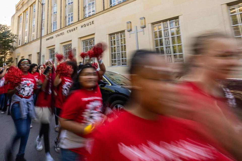 Thousands of women and members of the Girls Inc. of Tarrant County walk past the Federal Courthouse on West 10th Street for the 2023 Day of the Girl march in Fort Worth on Friday.