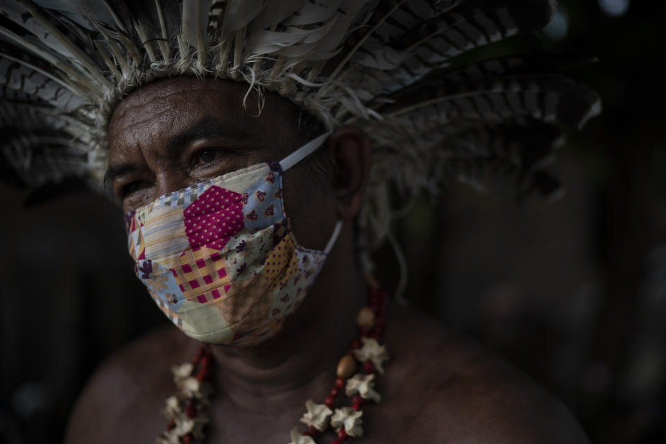 Pedro dos Santos, the leader of a community named Park of Indigenous Nations, poses for a photo, in Manaus, Brazil, May 10, 2020. Manaus' lack of the new coronavirus treatment prompted Pedro dos Santos to drink tea made of chicory root, garlic and lime to combat a high fever that lasted 10 days. (AP Photo/Felipe Dana)