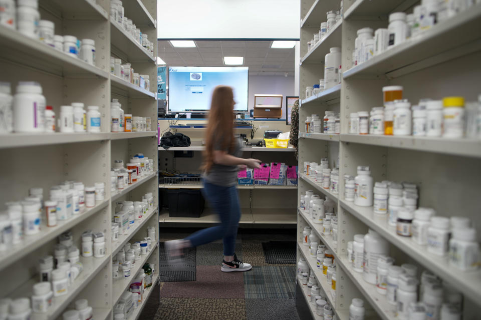 Christina McGowan fills orders at the Table Rock Pharmacy on Friday, Jan. 6, 2023, in Morganton, N.C. Drugstore chains are still trying to find enough employees to put a stop to temporary pharmacy closures. (AP Photo/Chris Carlson)