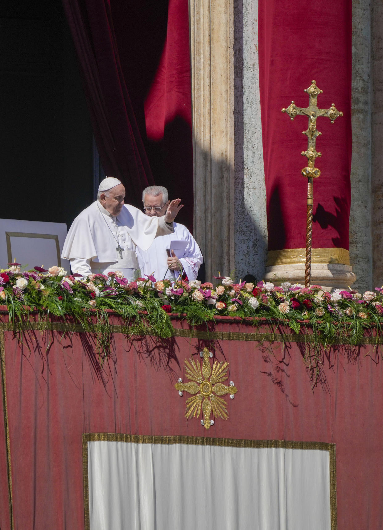 Pope Francis waves from the central lodge of the St. Peter's Basilica at The Vatican at the end of the Easter Sunday mass, Sunday, April 9, 2023. (AP Photo/Gregorio Borgia)