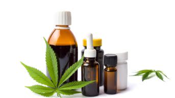 Marijuana plant and cannabis oil bottles isolated