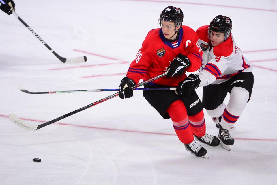 Jan 25, 2023; Langley, BC, CANADA; CHL Top Prospects team red forward Connor Bedard (98) controls the puck against CHL Top Prospects team white defenseman Hunter Brzustewicz (4) during the third period in the 2023 CHL Top Prospects ice hockey game at Langley Events Centre. Mandatory Credit: Anne-Marie Sorvin-USA TODAY Sports