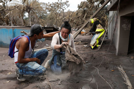 A woman reacts in an affected area after the eruption of the Fuego volcano in Escuintla, Guatemala, June 8, 2018. REUTERS/Carlos Jasso