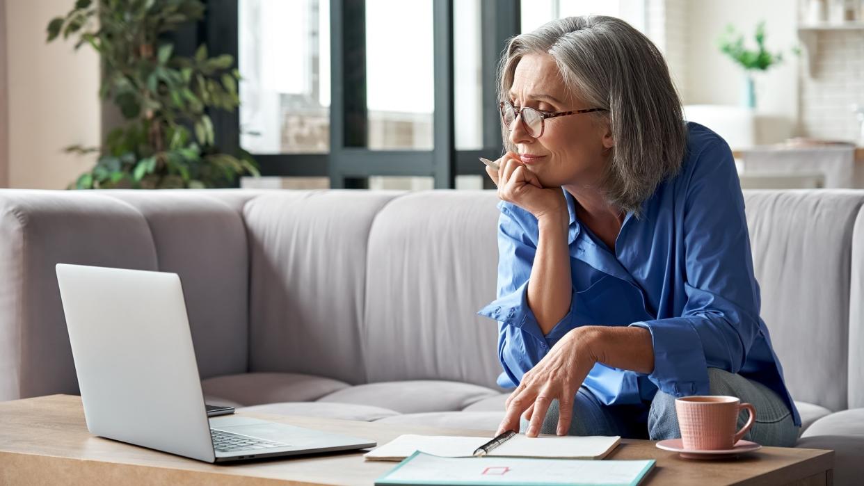 Senior mature older woman watching business training, online webinar on laptop computer remote working or social distance learning from home.