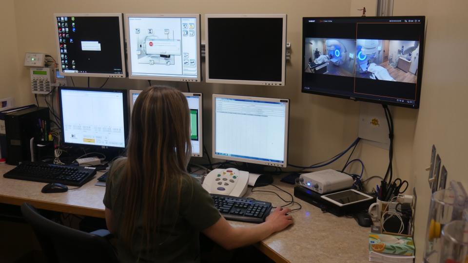 Haleigh Thompson, a radiation therapist at The University of Vermont Health Network - Champlain Valley Physicians Hospital, operates a 
linear accelerator at the FitzPatrick Cancer Center in northern New York. The accelerator provides radiation treatments that target patient tumors with a high degree of accuracy, sparing nearby healthy tissue.