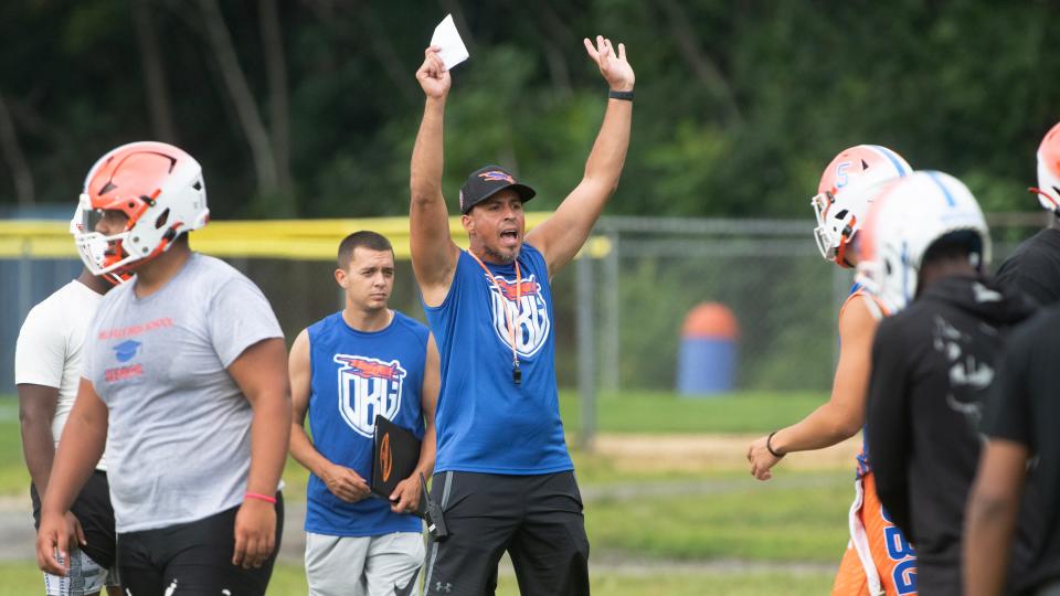Millville High School's head football coach Humberto Ayala instructs his players during Millville High School's first football practice of the season held at Millville High School on Monday, August 7, 2023.  