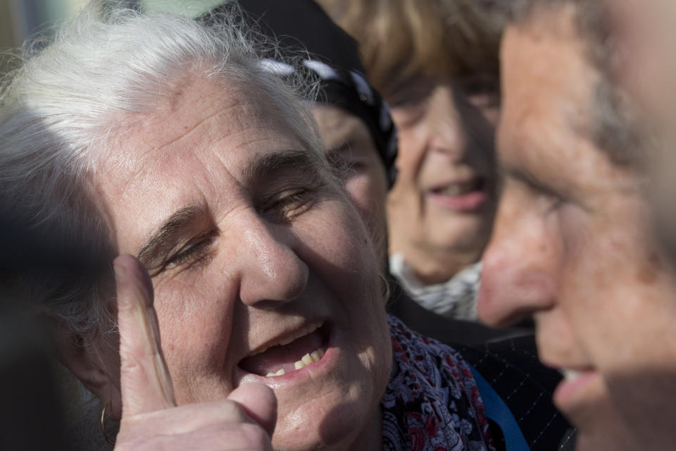 Munira Subasic of the Mothers of Srebrenica, left, haggles Peter Robinson of the U.S., lawyer for former Bosnian Serb leader Radovan Karadzic, after the court upheld Karadzic's conviction at International Residual Mechanism for Criminal Tribunals in The Hague, Netherlands, Wednesday, March 20, 2019. Nearly a quarter of a century since Bosnia's devastating war ended, Karadzic heard the final judgment upholding 2016 convictions for genocide, crimes against humanity and war crimes, and an increase from his 40-year sentence to life. (AP Photo/Peter Dejongl)