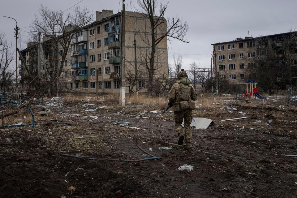 A Ukrainian soldier in Vuhledar last winter. The bastion of resistance has now been claimed by Russian forces after over two years of fighting reduced it to rubble (AP)