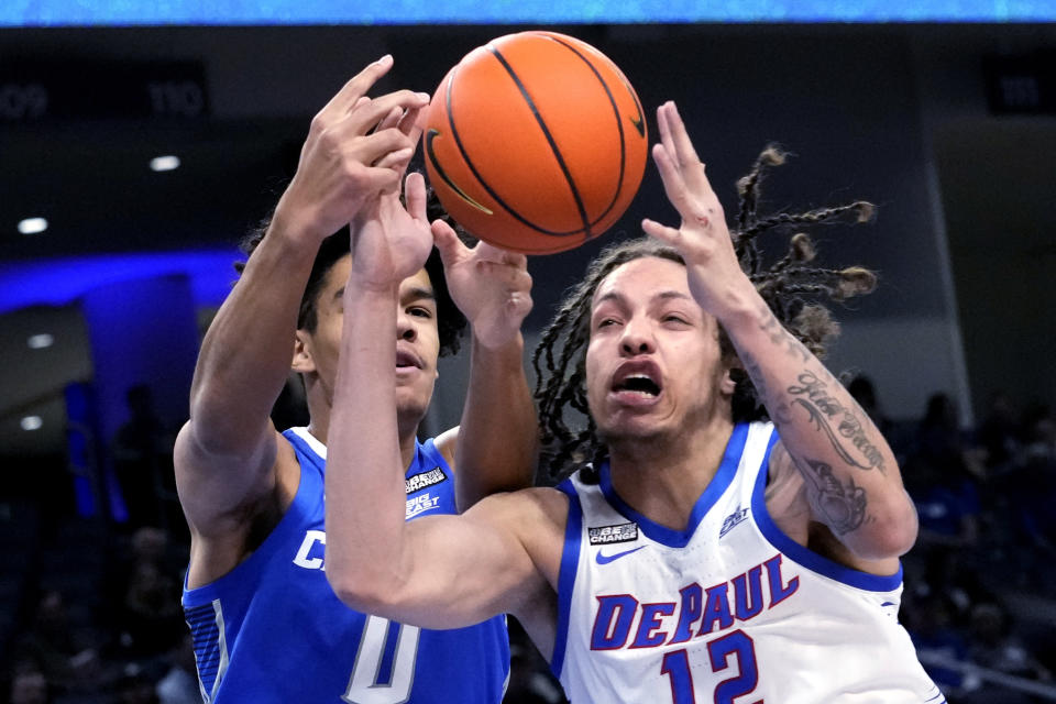 Creighton forward Jasen Green, left, and DePaul forward Mac Etienne battle for a rebound during the first half of an NCAA college basketball game in Chicago, Tuesday, Jan. 9, 2024. (AP Photo/Nam Y. Huh)