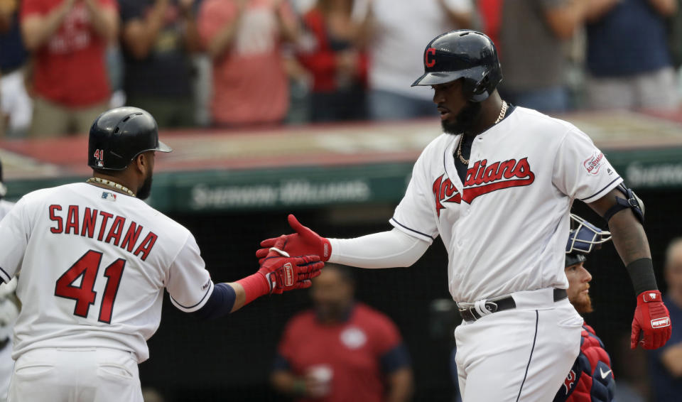 Cleveland Indians' Franmil Reyes, right, is congratulated by Carlos Santana after hitting a two-run home run in the first inning of a baseball game against the Boston Red Sox, Monday, Aug. 12, 2019, in Cleveland. Santana also scored on the play. (AP Photo/Tony Dejak)