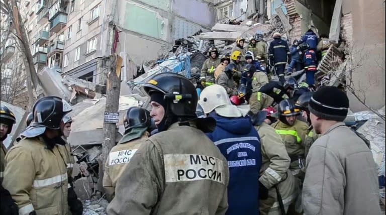 Rescue workers carry out a survivor of the gas blast at a residential building in Russia's Urals city of Magnitogorsk