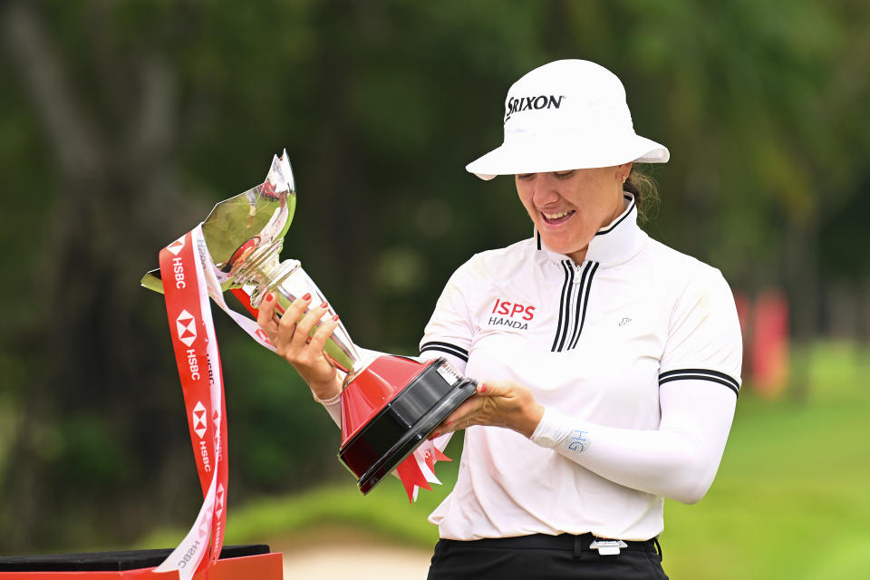 Hannah Green reacts to the trophy upon victory on the 18th green on Day Four of the HSBC Women’s World Championship at Sentosa Golf Club on March 03, 2024 in Singapore. (Photo by Ross Kinnaird/Getty Images)