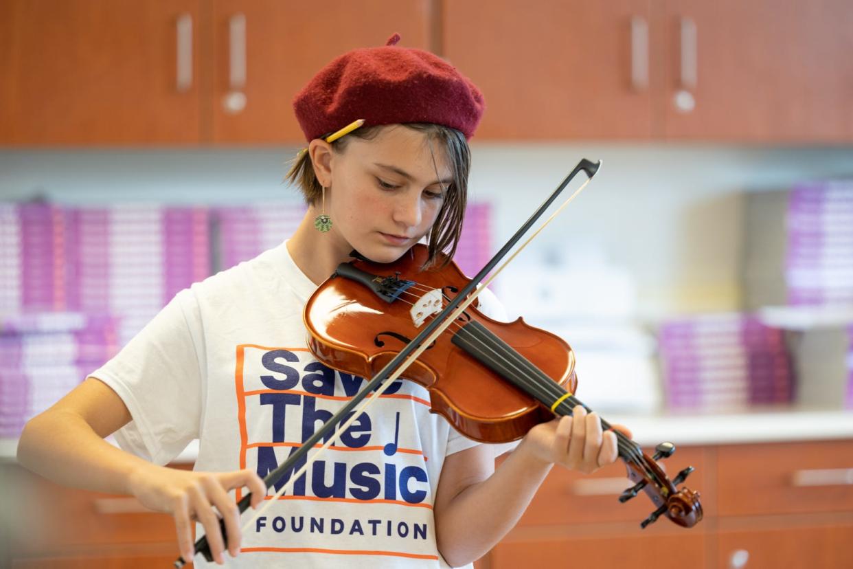 Esmé Holt, a sixth-grader from Arts I.M.P.A.C.T. Middle School (Interdisciplinary Model Program in the Arts for Children and Teachers), plays the violin in preparation for the Saturday Strings Festival on Nov. 5 at East High School.