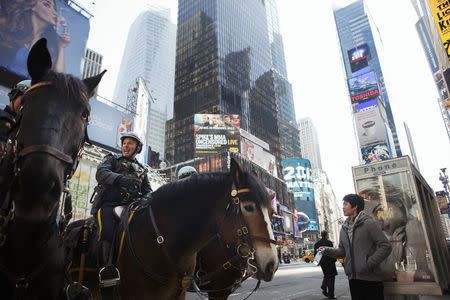 New York Police Department officers sit on their horses in Times Square during a warm winter day in New York in this March 6, 2012, file photo. REUTERS/Lucas Jackson/Files