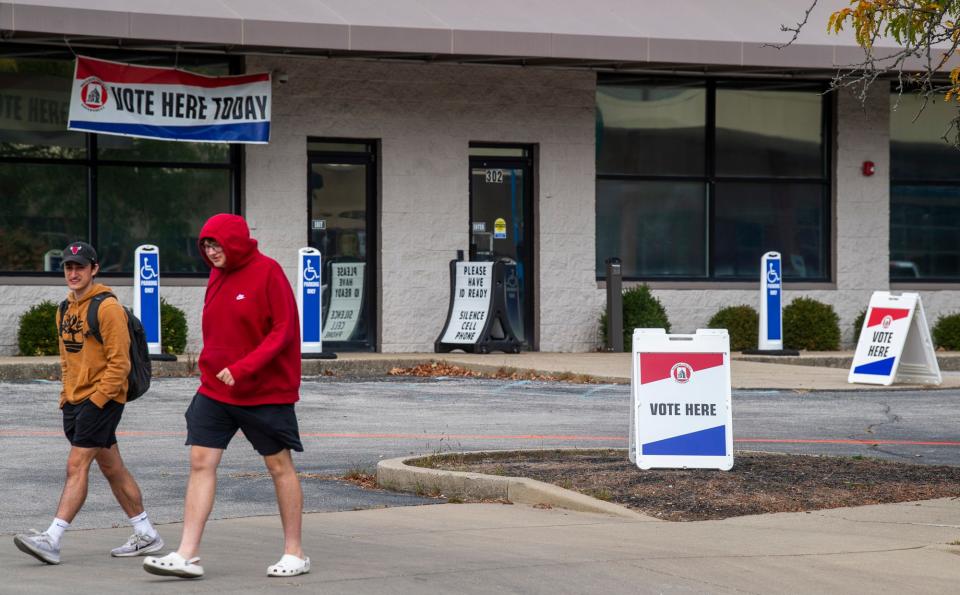 People walk by the Monroe County Election Central, which is open for early voting until noon Nov. 6, on Wednesday, Oct. 11, 2023.