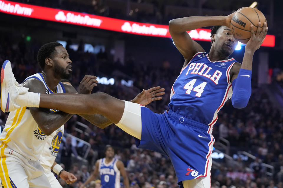 Philadelphia 76ers forward Paul Reed (44) grabs a rebound next to Golden State Warriors forward JaMychal Green during the first half of an NBA basketball game in San Francisco, Friday, March 24, 2023. (AP Photo/Jeff Chiu)