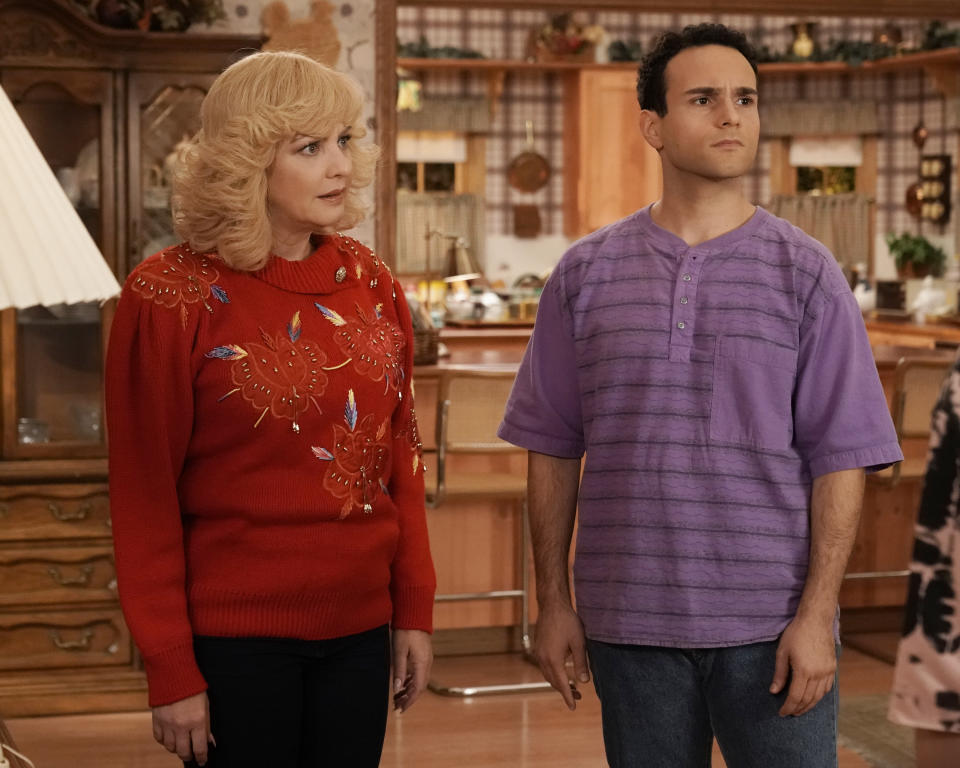 This image released by ABC shows Wendi McLendon-Covey as Beverly Goldberg, left, and Troy Gentile as Barry Goldberg in a scene from the comedy series "The Goldbergs." Costume designer Keri Smith creates the signature looks for the fictional Beverly. (Lisa Rose/ABC via AP)