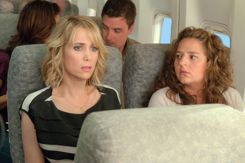 Kristen Wiig and Annie Mumolo sit anxiously on an airplane in a scene from "Bridesmaids"