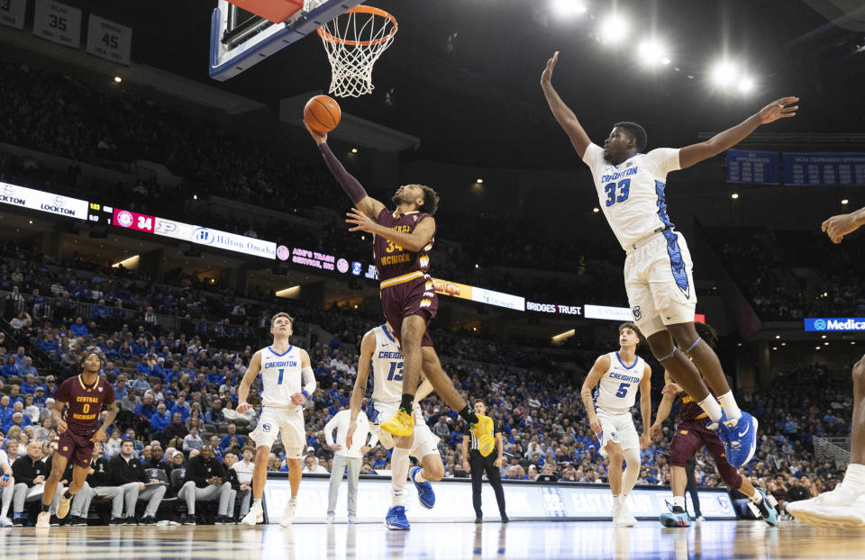 Central Michigan's Paul McMillan IV (34) shoots against Creighton's Fredrick King (33) during the first half of an NCAA college basketball game Saturday, Dec. 9, 2023, in Omaha, Neb. (AP Photo/Rebecca S. Gratz)